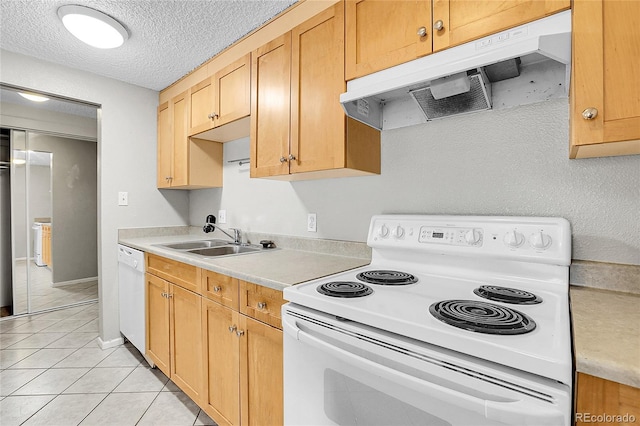 kitchen featuring sink, light tile patterned floors, a textured ceiling, and white appliances