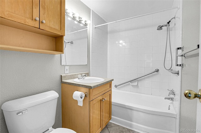 full bathroom featuring tile patterned flooring, vanity, tiled shower / bath combo, and toilet