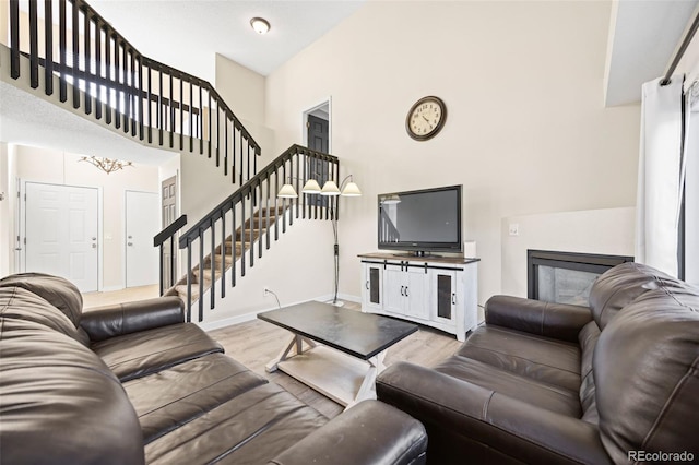 11100 Callaway Ct, Parker, CO 80138 - living area with a high ceiling, stairway, and light wood-style floors
