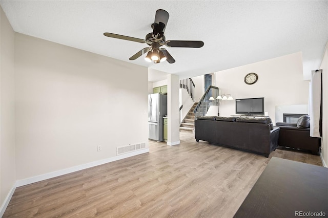 11100 Callaway Ct, Parker, CO 80138 - living room with stairway, a ceiling fan, and light wood-style floors