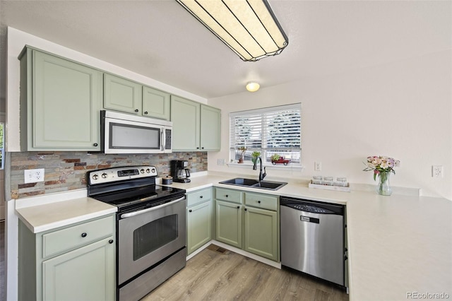 11100 Callaway Ct, Parker, CO 80138 - kitchen with stainless steel appliances, green cabinetry, and backsplash