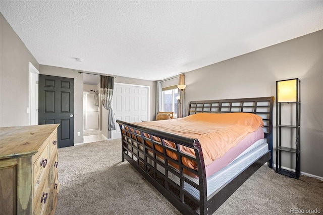 11100 Callaway Ct, Parker, CO 80138 - bedroom featuring carpet, a textured ceiling, a closet, and ensuite bath