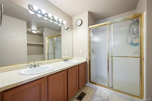 11100 Callaway Ct, Parker, CO 80138 - bathroom with a shower with shower door, double vanity, and tile patterned flooring