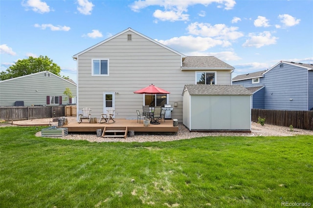 11100 Callaway Ct, Parker, CO 80138 - back of house featuring a storage shed, a wooden deck, a fenced backyard, and a shingled roof