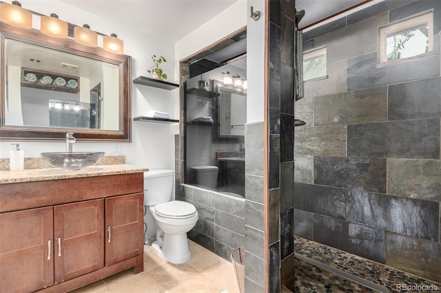 7579 Jay Ct, Arvada, CO 80003 - bathroom featuring toilet, walk in shower, vanity, and tile patterned flooring