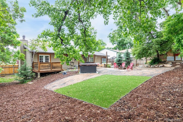 7579 Jay Ct, Arvada, CO 80003 - fenced backyard featuring a hot tub, a patio, and a deck