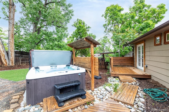 7579 Jay Ct, Arvada, CO 80003 - deck featuring a hot tub, french doors, and a fenced backyard