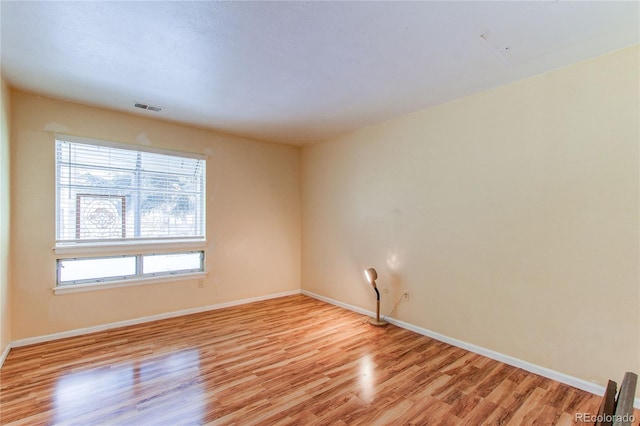 unfurnished room featuring light hardwood / wood-style floors and a healthy amount of sunlight