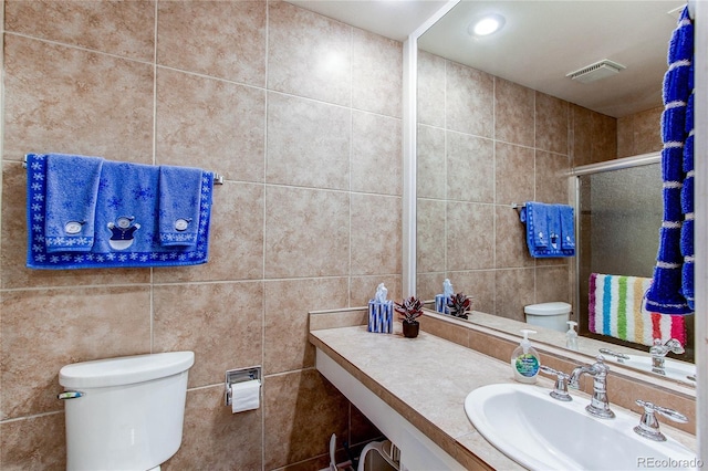 bathroom featuring vanity, toilet, and an enclosed shower