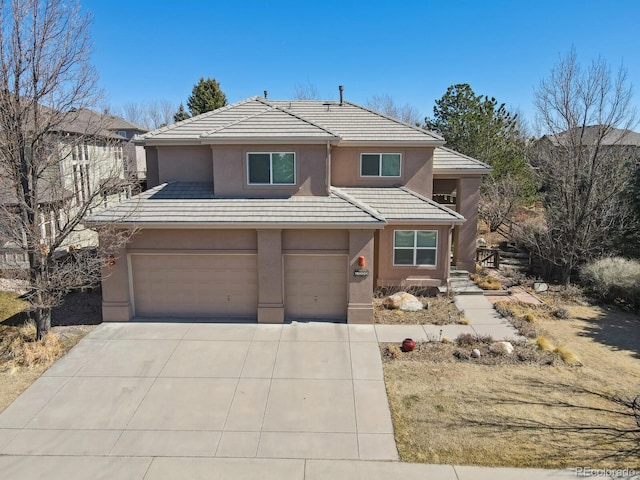 view of front of home featuring stucco siding, concrete driveway, an attached garage, and a tile roof