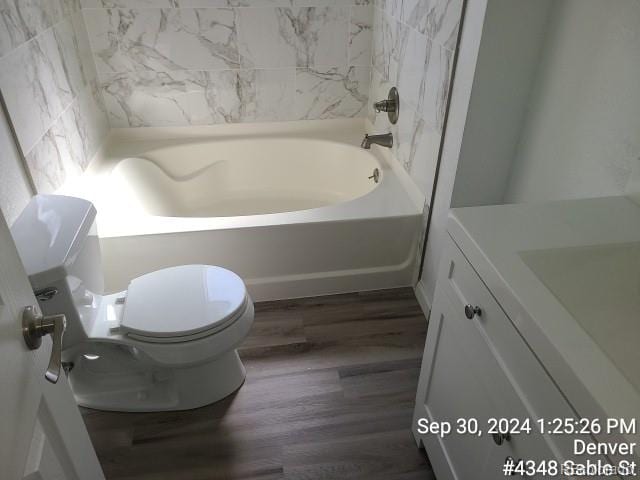 bathroom featuring wood-type flooring, vanity, and toilet