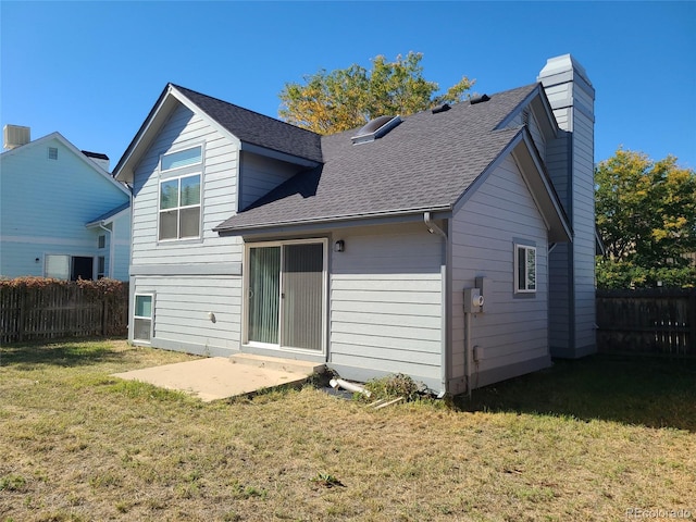 rear view of property featuring a lawn and a patio area