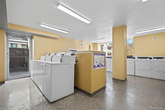 clothes washing area featuring independent washer and dryer