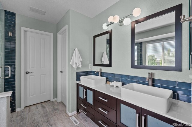 13322 Meadow Park Ln, Broomfield, CO 80020 - full bathroom with wood finished floors, double vanity, and tiled shower