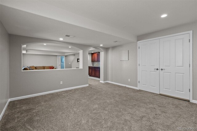 13322 Meadow Park Ln, Broomfield, CO 80020 - basement with carpet, arched walkways, and recessed lighting