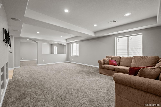 13322 Meadow Park Ln, Broomfield, CO 80020 - living room featuring a raised ceiling, carpet, recessed lighting, and arched walkways