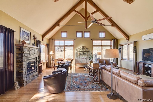living room featuring a ceiling fan, high vaulted ceiling, beam ceiling, and wood finished floors