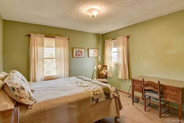 carpeted bedroom with baseboards, a textured ceiling, and multiple windows