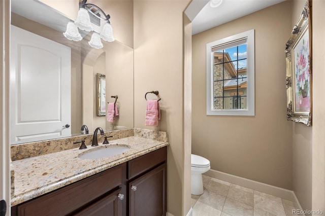 bathroom with vanity, tile patterned flooring, and toilet