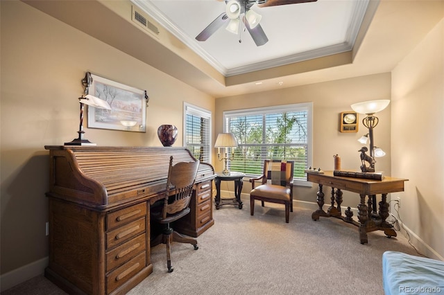 home office featuring ornamental molding, a ceiling fan, light colored carpet, a tray ceiling, and baseboards
