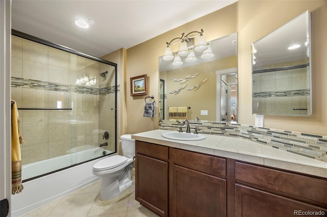 full bathroom featuring tile patterned floors, enclosed tub / shower combo, toilet, vanity, and tasteful backsplash