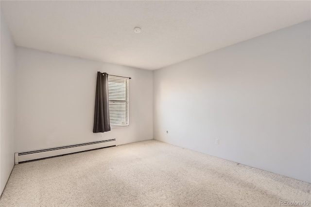 carpeted empty room with baseboard heating