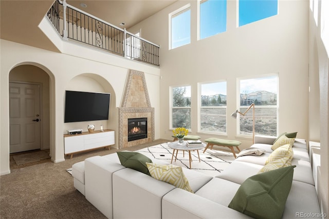 carpeted living room with a high ceiling