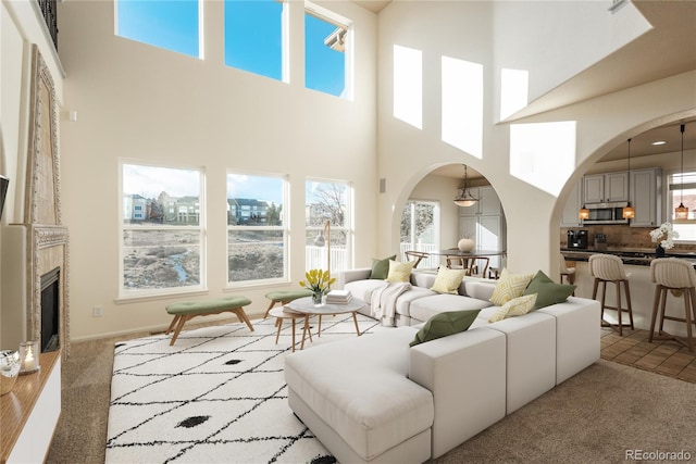 living room featuring light colored carpet and a high ceiling