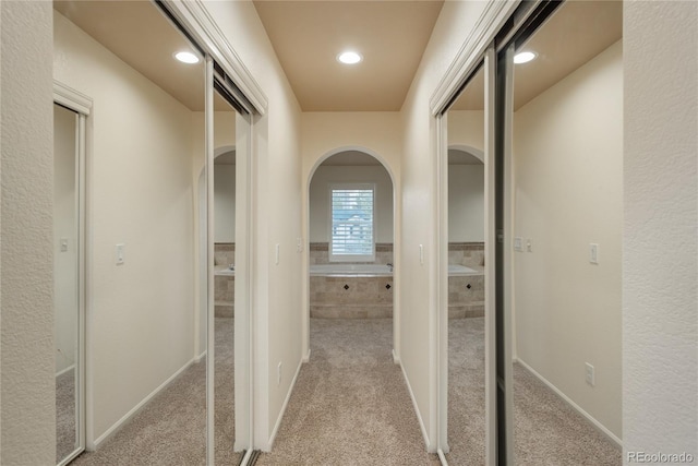 corridor with light colored carpet