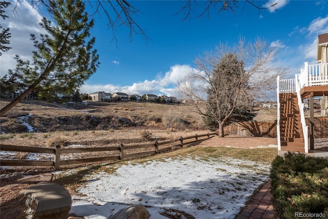 snowy yard with a wooden deck