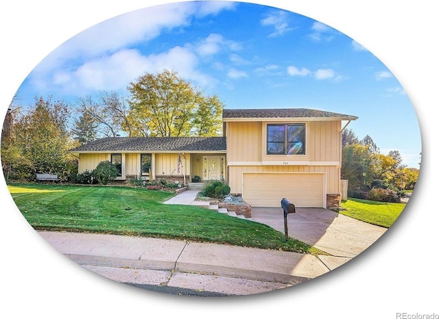 tri-level home with a garage, driveway, and a front lawn