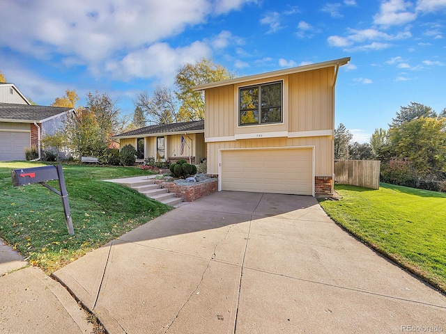 split level home featuring driveway, brick siding, a front yard, and fence