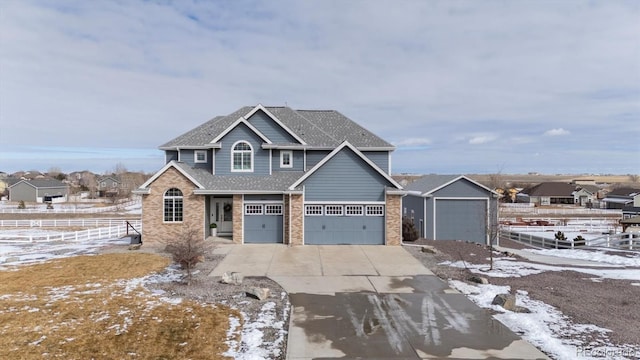 view of front facade featuring concrete driveway, a residential view, roof with shingles, fence, and brick siding