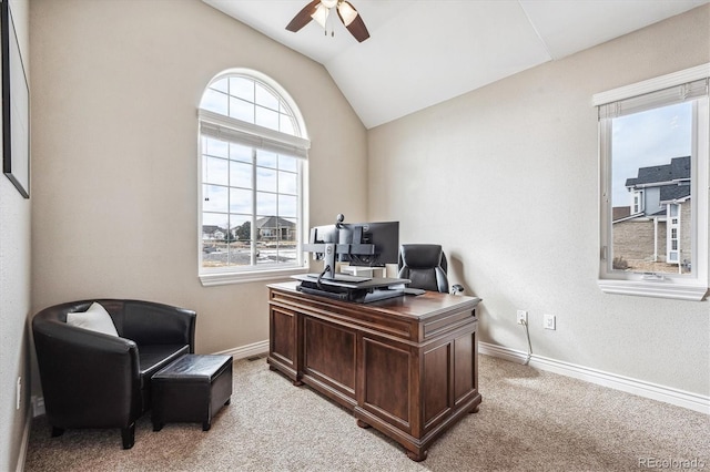 office space featuring lofted ceiling, light colored carpet, ceiling fan, and baseboards