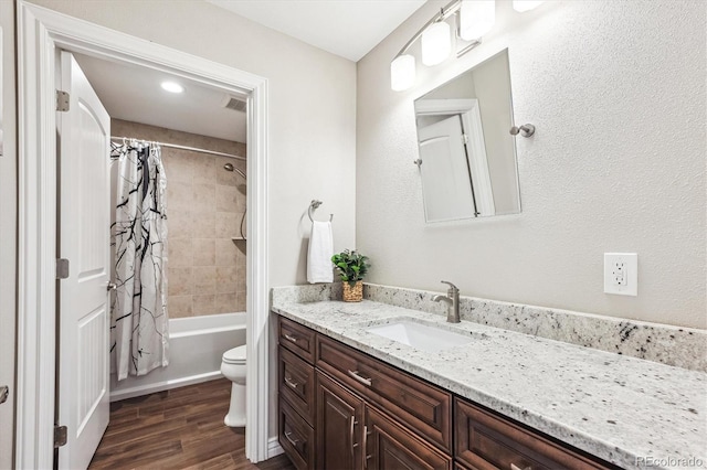 bathroom featuring visible vents, toilet, shower / bath combo with shower curtain, vanity, and wood finished floors