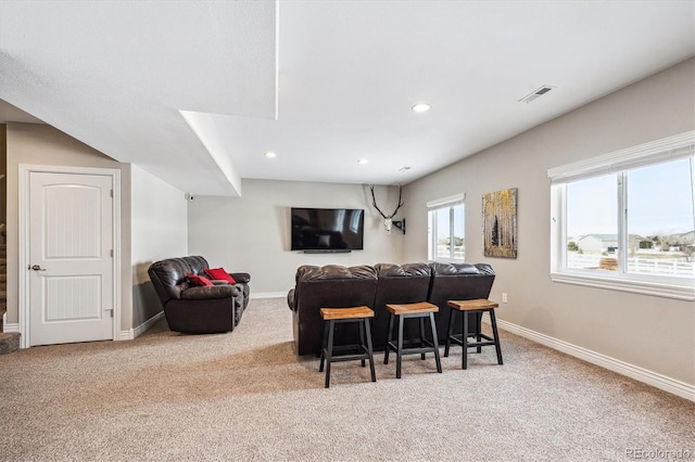 living area with recessed lighting, visible vents, light carpet, and baseboards