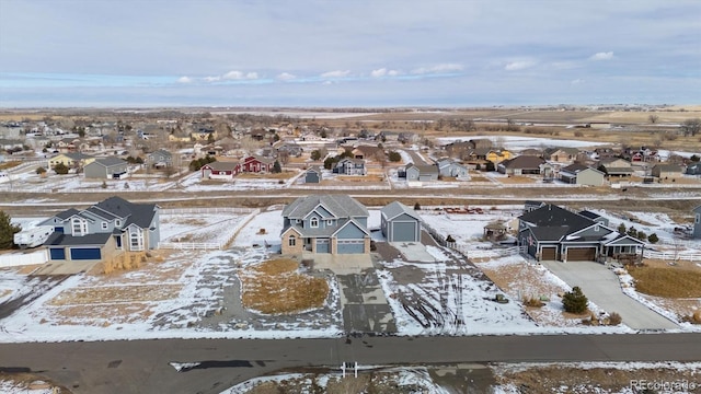 snowy aerial view featuring a residential view