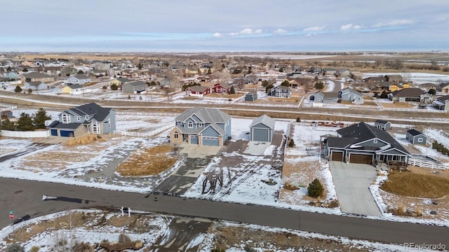 snowy aerial view with a residential view