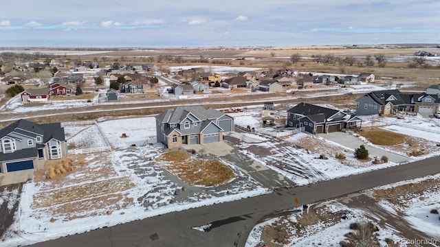 snowy aerial view featuring a residential view