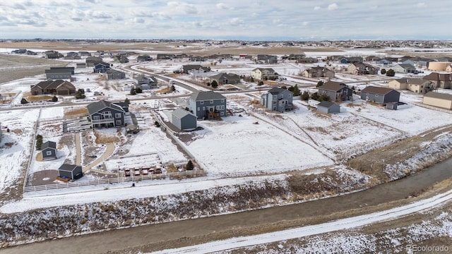 snowy aerial view featuring a residential view