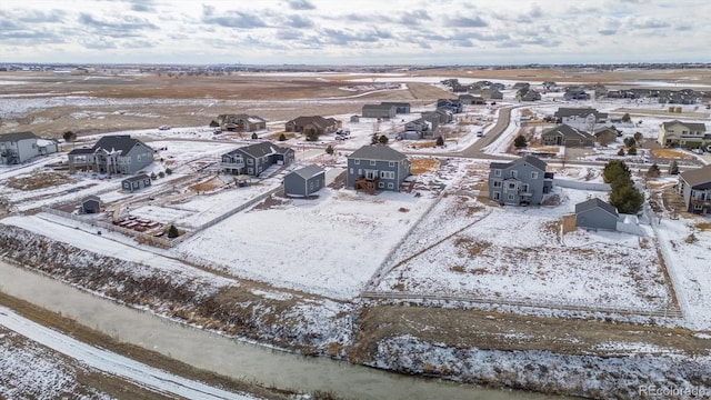 snowy aerial view featuring a residential view