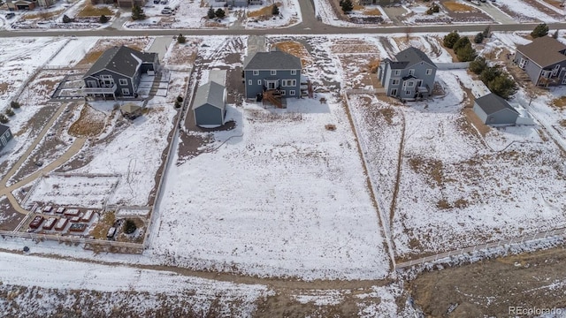 snowy aerial view with a residential view