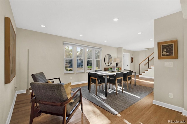 dining room with stairway, recessed lighting, wood finished floors, and baseboards