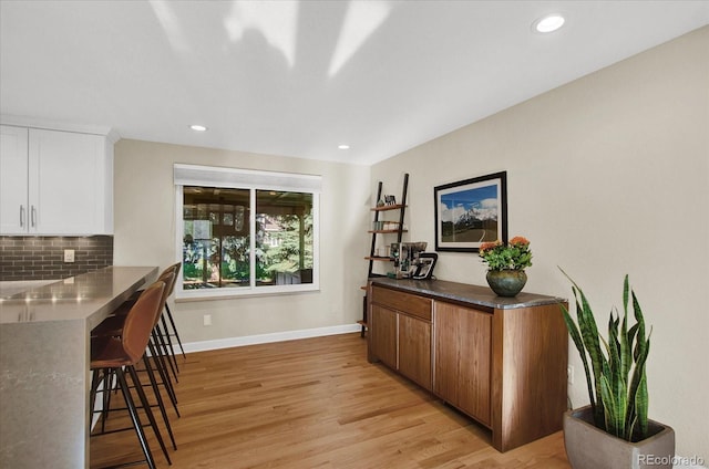 home office featuring light wood-type flooring, baseboards, and recessed lighting