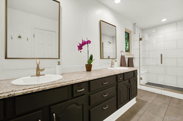 full bathroom featuring a stall shower, tile patterned flooring, a sink, and double vanity