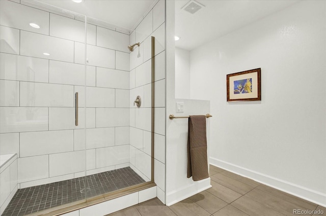 full bathroom featuring a stall shower, visible vents, and baseboards