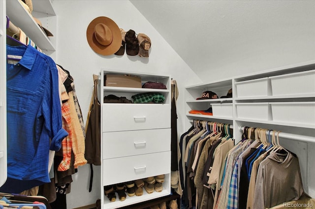 walk in closet with lofted ceiling