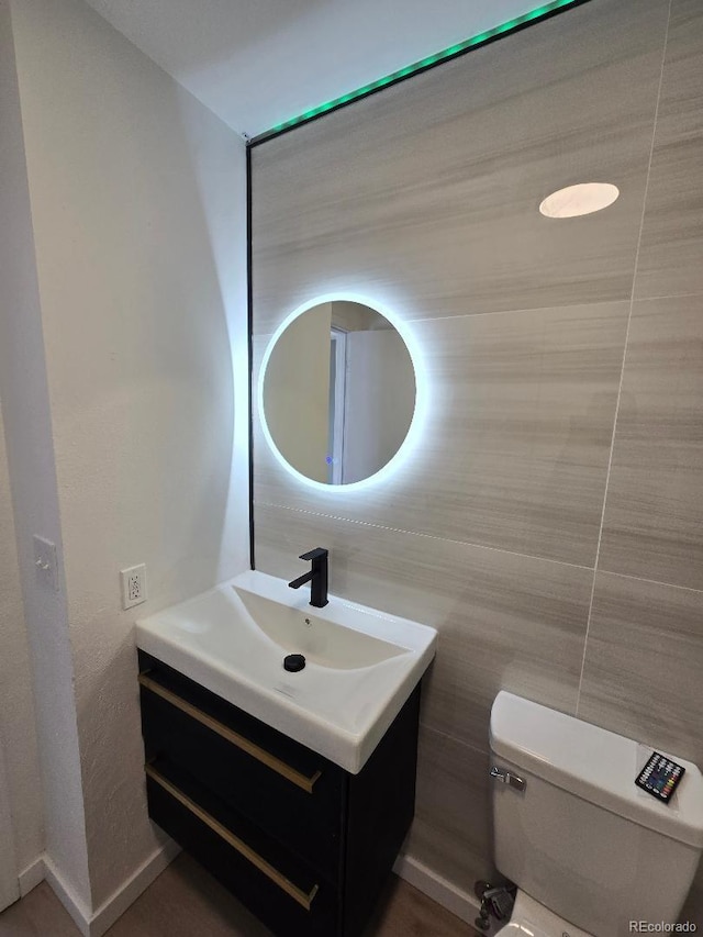 half bath featuring toilet and vanity