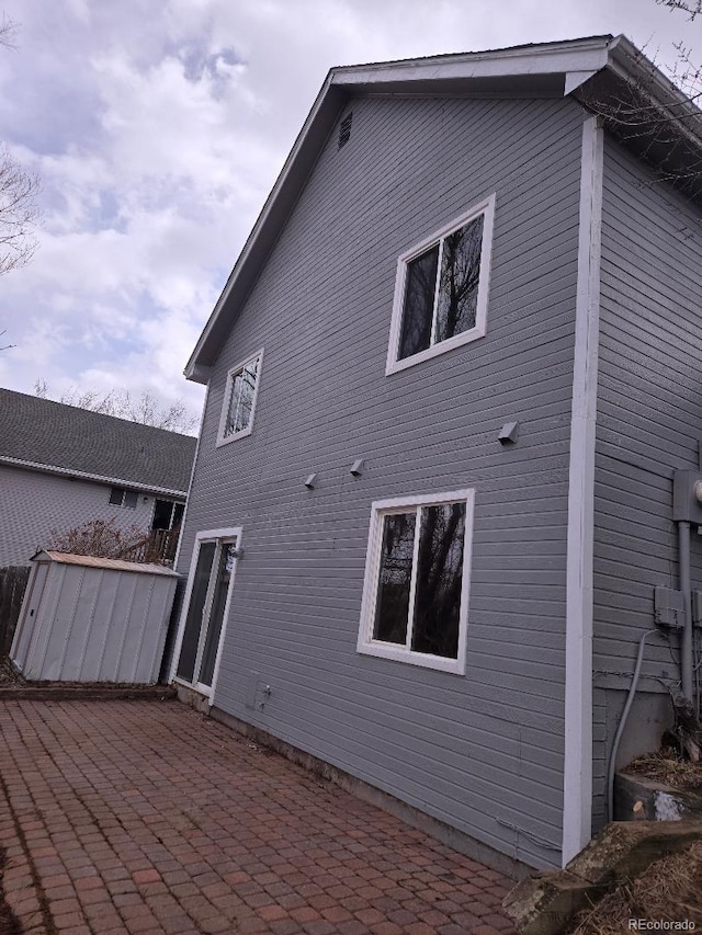 rear view of property featuring a patio area