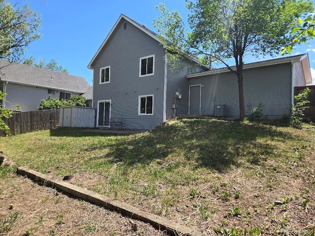 17605 E Temple Dr, Aurora, CO 80015 - rear view of house featuring a storage unit, central AC, and an outbuilding